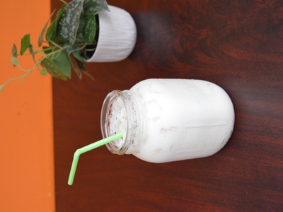 Creamy horchata in a mason jar with a green straw